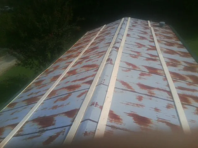 Rusted metal roof panels with new wood purlins before replacement — Storm Damage Roof Repair in Yountville by Roofing Brothers